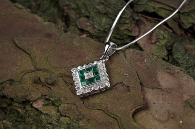 Lot 603 - An emerald and diamond pendant necklace