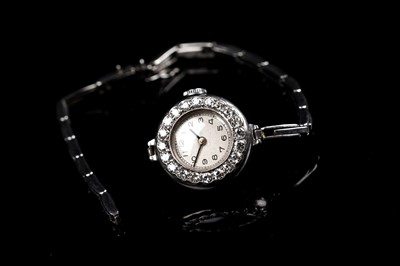 Lot 453 - A diamond set platinum cased cocktail watch