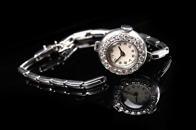 Lot 453 - A diamond set platinum cased cocktail watch