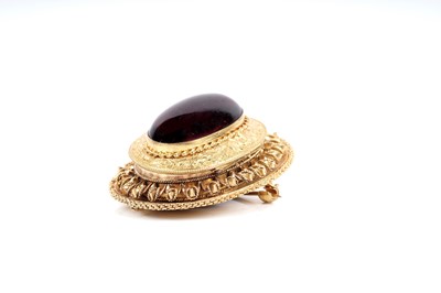 Lot 509 - A Victorian garnet and yellow gold locket brooch