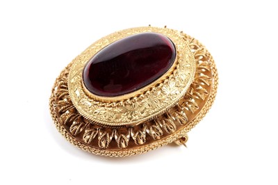 Lot 509 - A Victorian garnet and yellow gold locket brooch