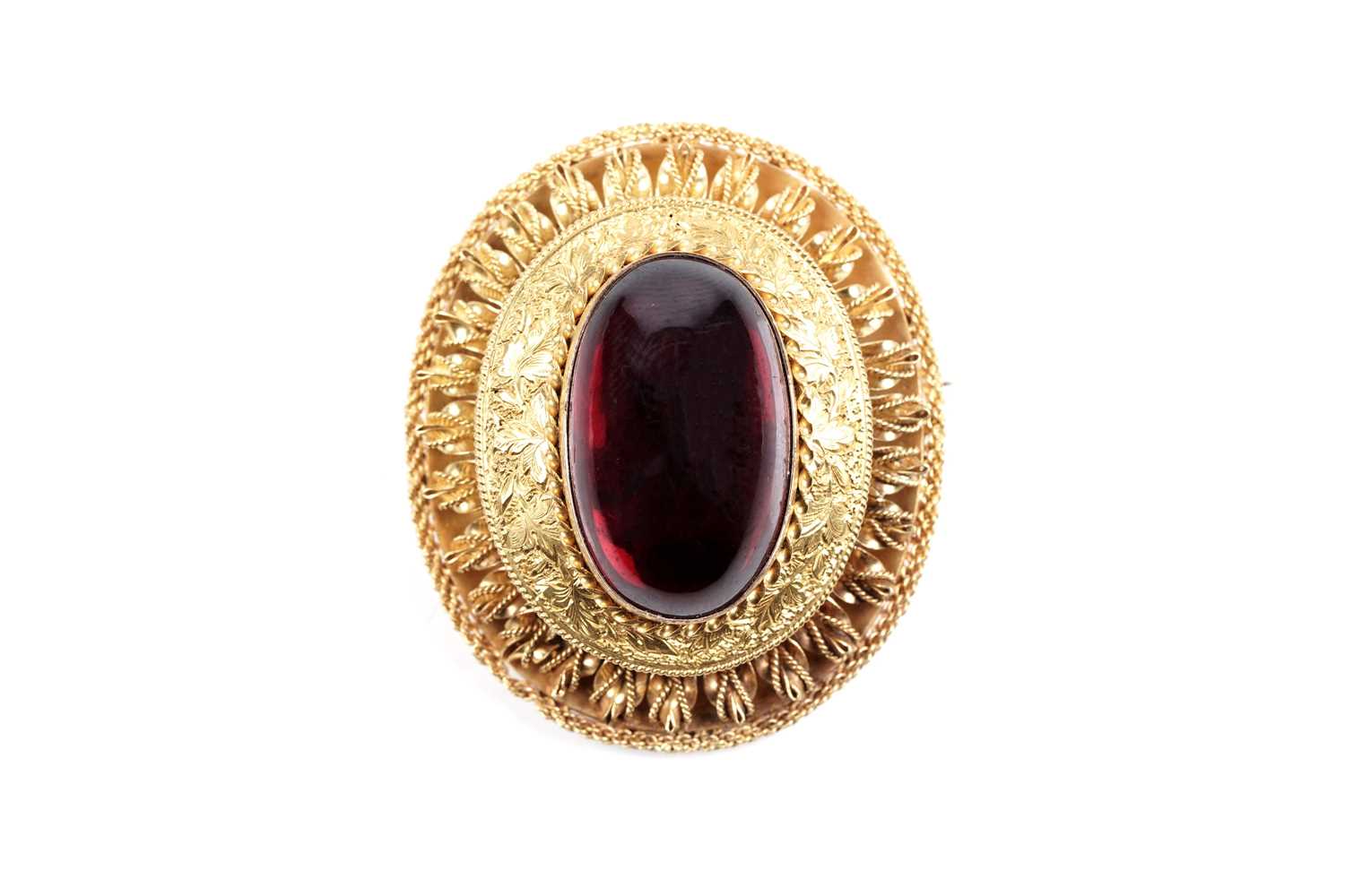 Lot 509 - A Victorian garnet and yellow gold locket brooch