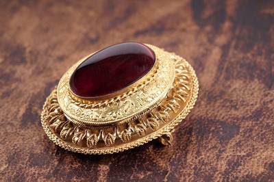 Lot 509 - A Victorian garnet and yellow gold locket brooch