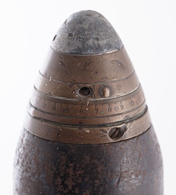 Lot 90 - A Second World War six-pounder gun-sight, a shell and box