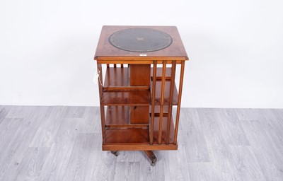 Lot 58 - A 20th Century yew veneered and walnut banded revolving bookcase