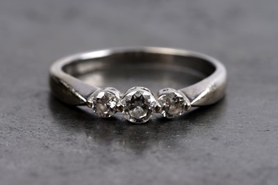 Lot 23 - A contemporary diamond and 18ct white gold three-stone ring