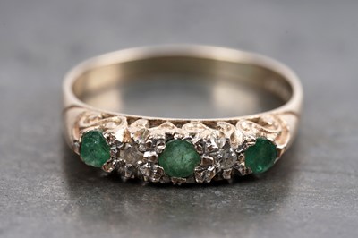 Lot 67 - A three-stone emerald and diamond ring