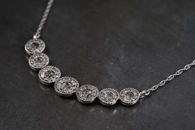 Lot 102 - A modern diamond necklace in the form of seven graduated roundels