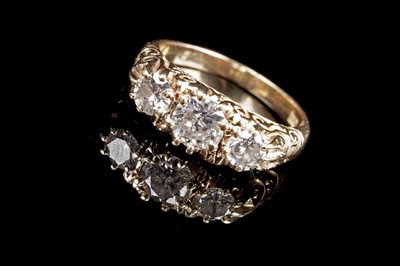Lot 550 - A Victorian style three stone diamond ring