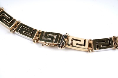 Lot 551 - An 18ct yellow and white gold Greek-Key pattern necklace