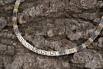Lot 551 - An 18ct yellow and white gold Greek-Key pattern necklace