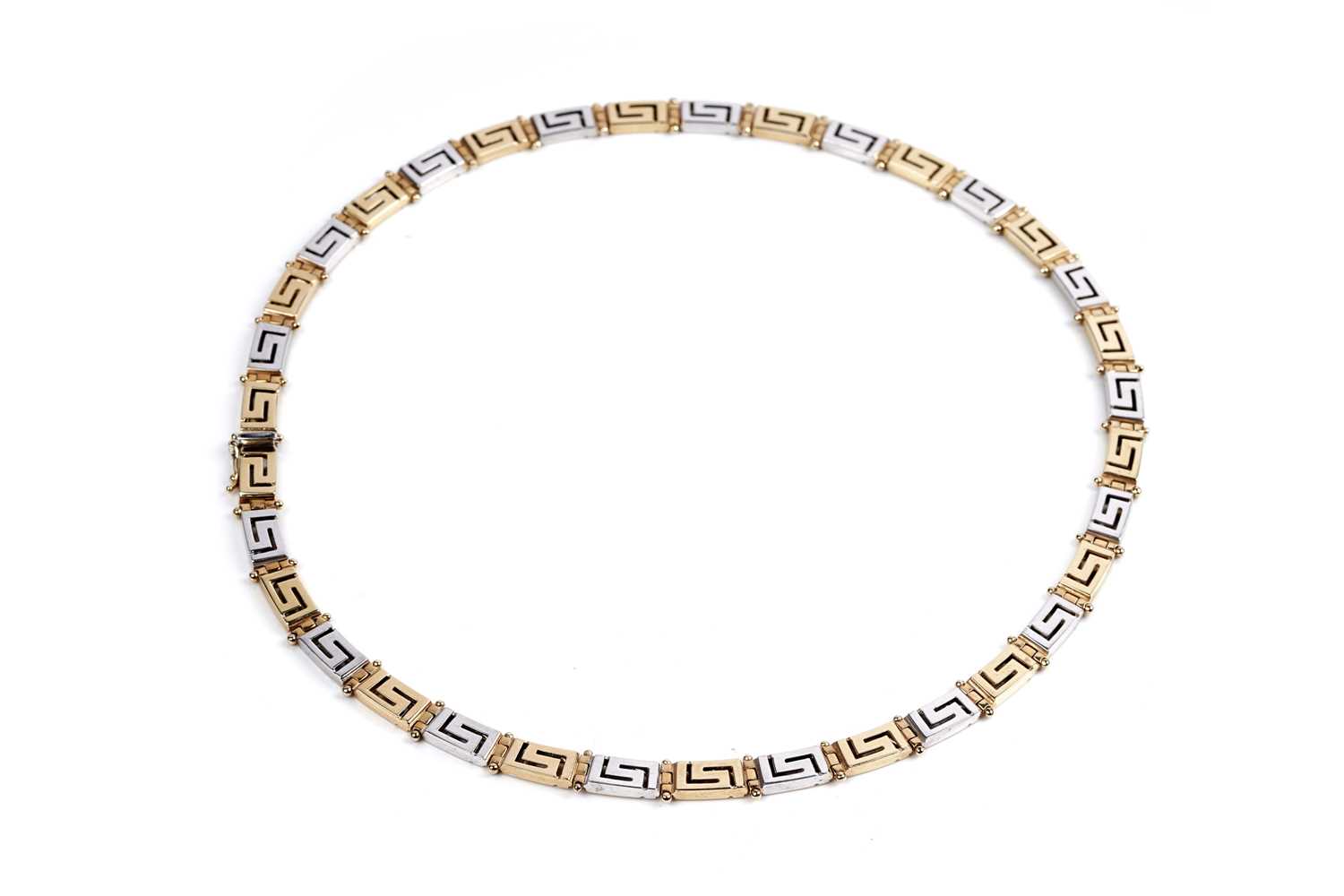 Lot 551 - An 18ct yellow and white gold Greek-Key pattern necklace
