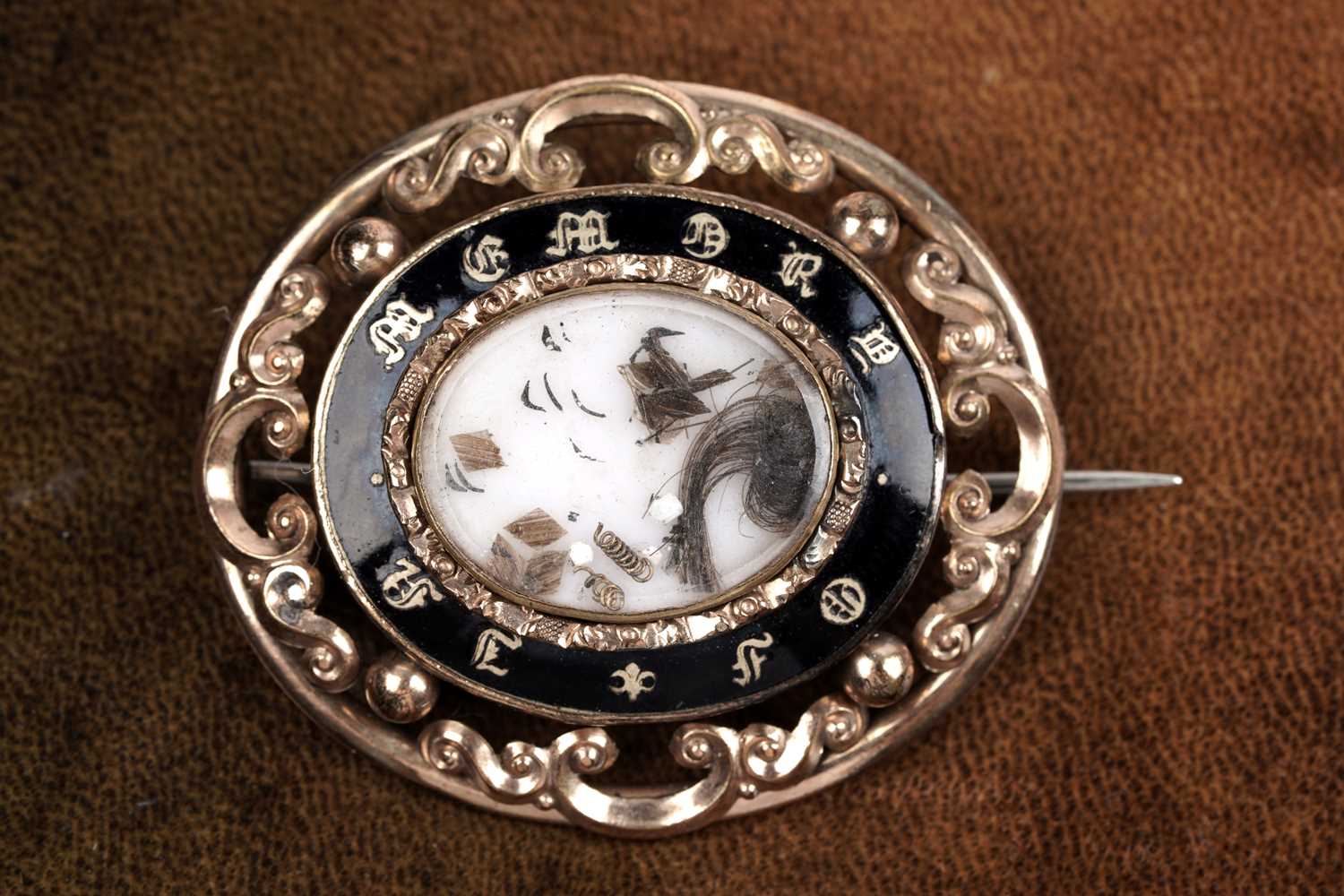 Lot 72 - A Victorian enamelled mourning brooch