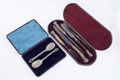Lot 324 - A carving set; and two fruit serving spoons