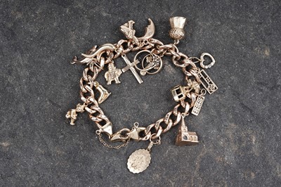 Lot 132 - A 9ct rose gold charm bracelet