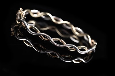 Lot 161 - A contemporary yellow and white 9ct gold bangle