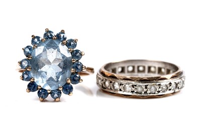 Lot 62 - A "Swiss blue" topaz flowerhead pattern dress ring, and a spinel eternity ring