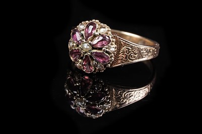 Lot 12 - A Victorian garnet and seed pearl flowerhead pattern ring