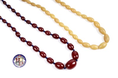 Lot 46 - Two 1930's amber style bead necklaces; and a 1916 enamelled silver crown