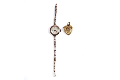 Lot 275 - A lady's 9ct rose gold cased wristwatch; and a heart-shaped locket