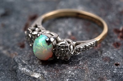 Lot 29 - A three-stone opal and diamond ring