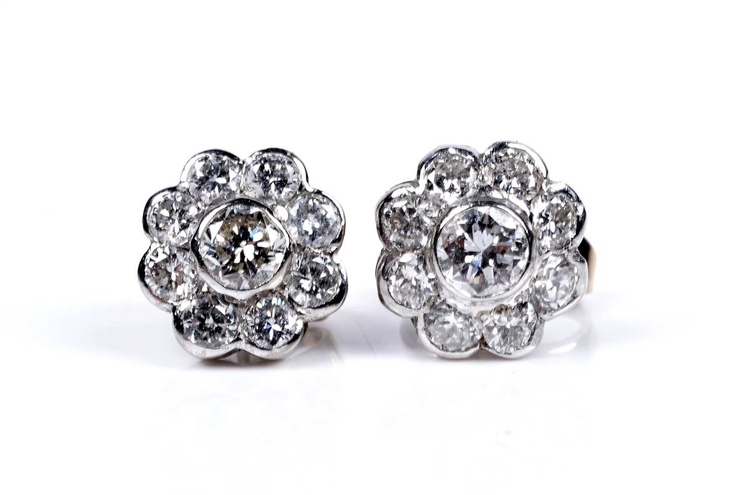Lot 3 - A pair of diamond flowerhead pattern stud earrings