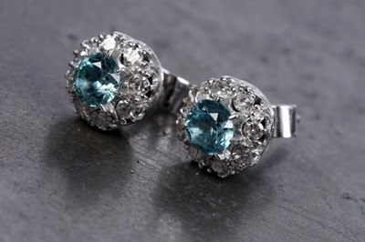 Lot 28 - A pair of blue topaz and diamond cluster earrings