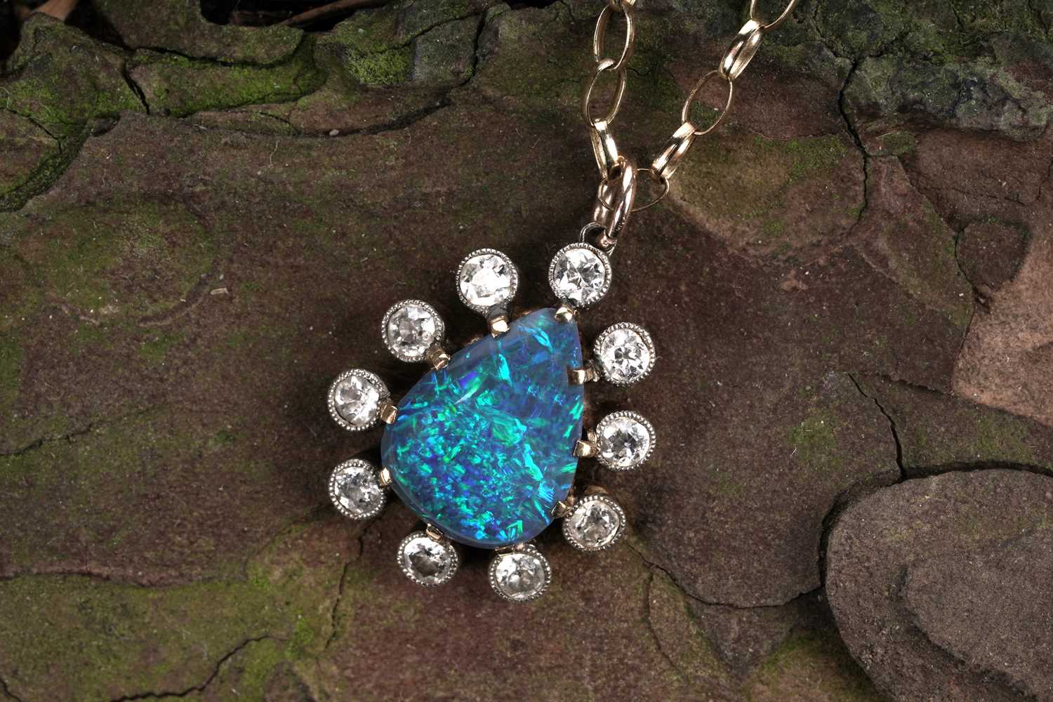 Lot 552 - A black opal and diamond pendant