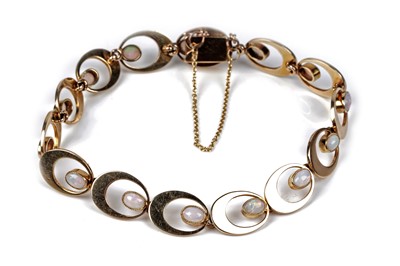 Lot 555 - An opal and yellow gold bracelet