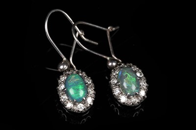 Lot 557 - A pair of black opal and diamond cluster earrings