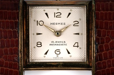 Lot 458 - Hermes: a gilt metal and leather covered purse watch