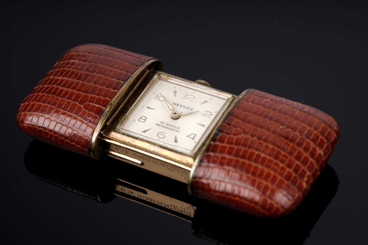 Lot 458 - Hermes: a gilt metal and leather covered purse watch