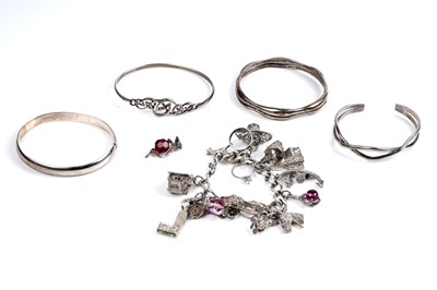 Lot 99 - Silver bangles and a charm bracelet