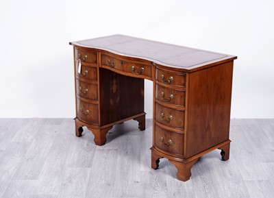 Lot 70 - Bevan Funnell: a Reprodux walnut and banded serpentine fronted writing desk