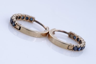 Lot 84 - A contemporary pair of sapphire hoop earrings