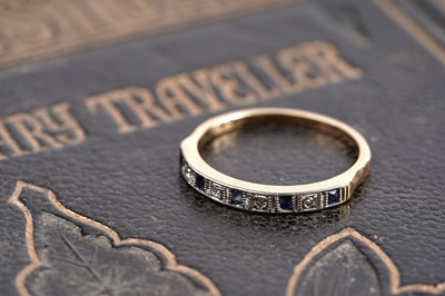 Lot 144 - An early 20th Century Art Deco sapphire and diamond half hoop eternity ring