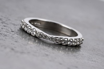 Lot 616 - A diamond half hoop eternity ring