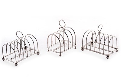 Lot 361 - Three silver toast racks
