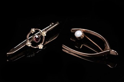 Lot 193 - Two antique brooches, including a lucky wishbone brooch set with a cabochon opal