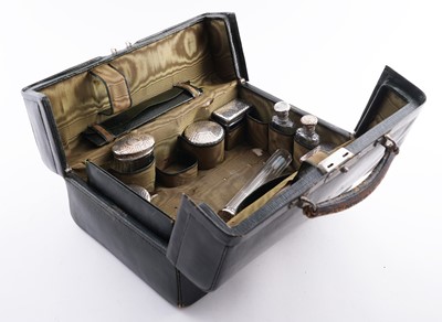 Lot 352 - An Edwardian Harrods leather Gladstone vanity case with silver-mounted dressing items