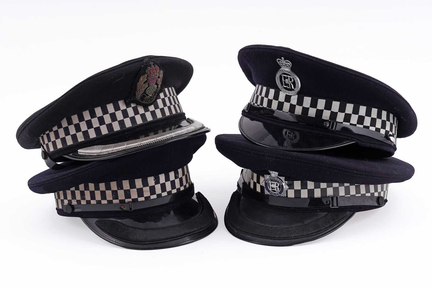 Lot 147 - A collection of four peaked police officer’s caps