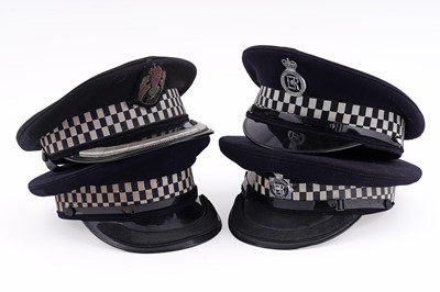 Lot 147 - A collection of four peaked police officer’s caps