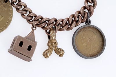 Lot 313 - A 9ct rose gold charm bracelet, with fob George III 1794 gold guinea, and sovereigns