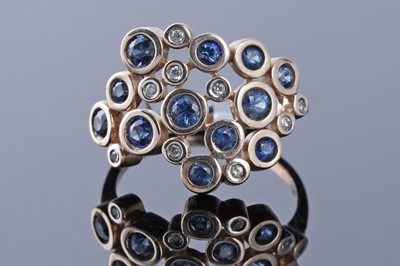 Lot 197 - A modern blue and white sapphire ring
