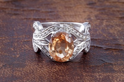 Lot 200 - A sphene and diamond ring