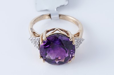 Lot 215 - An amethyst and white sapphire dress ring
