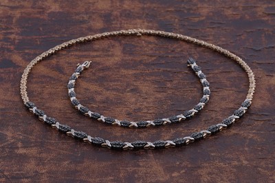 Lot 225 - A black and white diamond necklace and bracelet