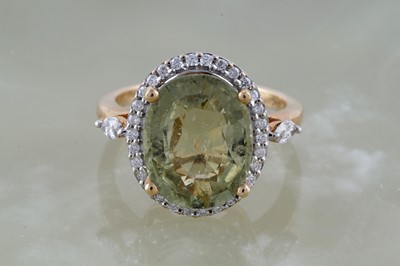 Lot 234 - A golden beryl and diamond cluster dress ring