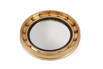 Lot 1056 - A late 19th/early 20th Century Regency style circular mirror