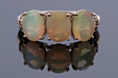 Lot 248 - A faceted opal and cinnamon-diamond dress ring